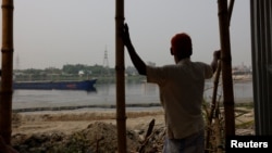 FILE - Nurul Islam, 70, looks over the Buriganga River, where he used to fish, in Dhaka, Bangladesh, March 18, 2023.
