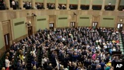FILE - Poland's lawmakers vote in parliament, in Warsaw, May 26, 2023. President Andrzej Duda announced, Aug. 8, 2023, that the country would hold its parliamentary election on Oct. 15.