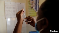 FILE - A nurse fills a syringe with malaria vaccine before administering it to an infant at the Lumumba Sub-County hospital in Kisumu, Kenya, July 1, 2022. Nigeria announced April 17, 2023, that it has given provisional approval to Oxford University's new R21 malaria vaccine. 