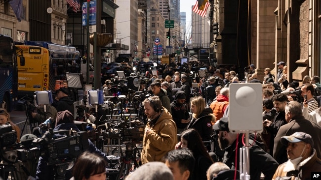 Members of the media gather outside Trump Tower in New York City, April 3, 2023.