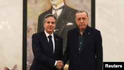 U.S. Secretary of State Antony Blinken, left, shakes hands with Turkish President Recep Tayyip Erdogan during their meeting at Esenboga airport in Ankara, Turkey, Feb. 20, 2023. 
