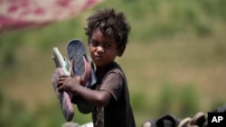 Waste picker Arjun, 6, works at garbage dump site during a heat wave on the outskirts of Jammu, India, on June 20, 2024.