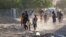 FILE: People flee their neighborhoods amid fighting between the army and paramilitaries in Khartoum on April 19, 2023, following the collapse of a 24-hour truce.
