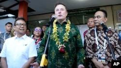 FILE - Elon Musk, center, talks to the media during the launch of Starlink satellite internet service for a facility in Bali, Indonesia, May 19, 2024. Indonesia is wooing Musk to launch more satellites from its territory.