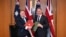 Secretary of State for Defense of the United Kingdom Grant Shapps (L) and Australian Defense Minister Richard Marles exchange Defense Treaty documents during a meeting at Parliament House in Canberra, March 21, 2024. (AAP Image/Lukas Coch via Reuters)