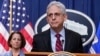 FILE — Attorney General Merrick Garland speaks at the Department of Justice in Washington, April 13, 2023, as Deputy Attorney General Lisa Monaco, left, stands by.