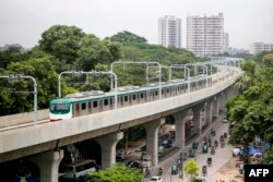 A metro train rides along a transit line in Dhaka, Aug. 25, 2024. Bangladesh's metro railine in the notoriously congested capital Dhaka resumed, more than a month after it was closed during peak of student-led protests.