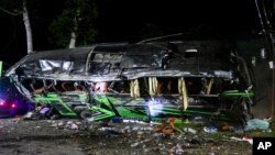 The wreckage of a bus lies on the side of a road following an accident in Subang, West Java, Indonesia, May 11, 2024.