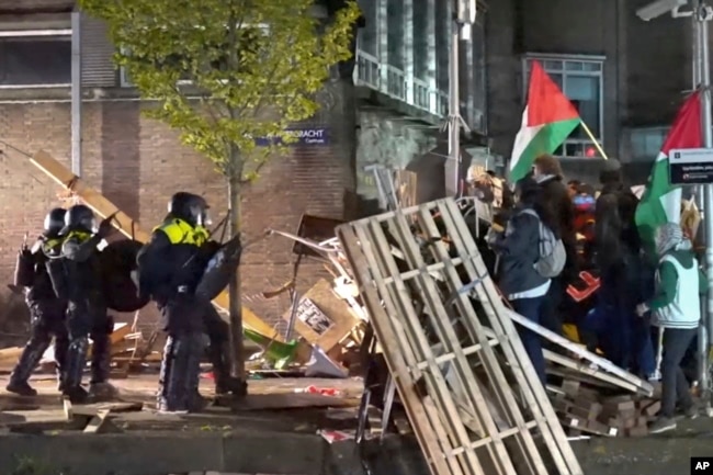 In this image taken from video, police arrests some 125 activists as they broke up a pro-Palestinian demonstration camp at the University of Amsterdam in Amsterdam, the Netherlands, Tuesday, May 7, 2024. (AP Photo InterVision)