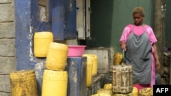 A water vendor fills up jerry cans at a water point at the Mathare slum in Nairobi, Kenya, March 22, 2023.