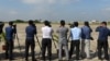 FILE - Cambodian journalists take pictures at a military airbase in Phnom Penh, Nov. 20, 2018. USAID announced in July a $7 million grant to bolster independent media in the country.