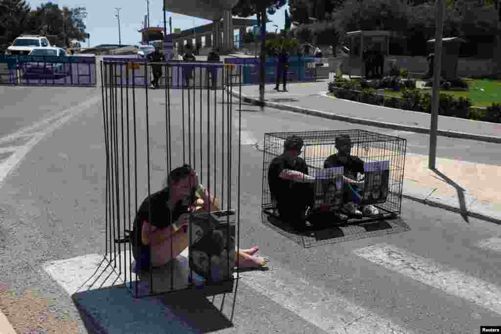 Family members of Israeli hostages held in Gaza since the deadly October 7 attack by Hamas, protest in cages to have their loved ones returned, outside the Knesset, Israel&#39;s parliament, in Jerusalem.