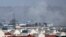 FILE - Smoke rises from a deadly explosion outside the airport in Kabul, Afghanistan, Aug. 26, 2021.
