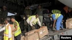 People move boxes after an Indian Air Force flight landed with medical aid, following the crisis in Sudan's capital Khartoum, at the military airport of Port Sudan, Sudan, May 18, 2023. 