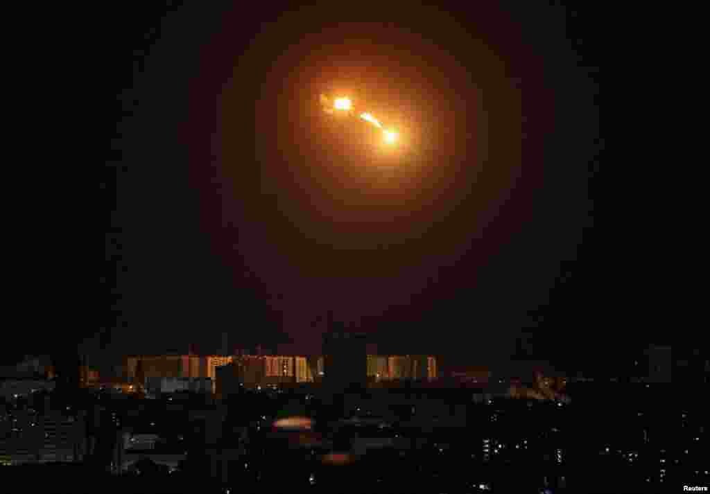 An explosion of a drone is seen in the sky over the city during a Russian drone strike, in Kyiv, Ukraine.