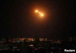 An explosion of a drone is seen in the sky over the city during a Russian drone strike, in Kyiv, Ukraine, May 8, 2023.