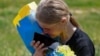 Ukrainian police officer and prisoner of war (POW) Mariana reacts while she speaks with her mother via phone after a swap, amid Russia's attack on Ukraine, at an unknown location in Ukraine.