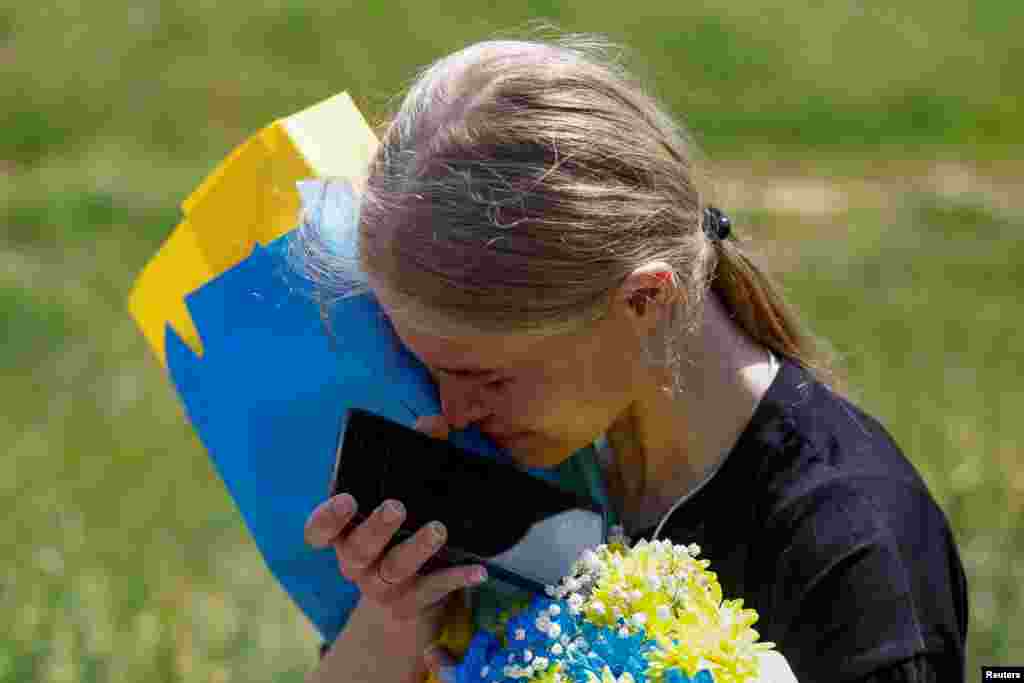 Ukrainian police officer and prisoner of war (POW) Mariana reacts while she speaks with her mother via phone after a swap, amid Russia's attack on Ukraine, at an unknown location in Ukraine.