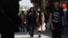 Iranian women walk on a street amid the implementation of the new hijab surveillance in Tehran, Iran, April 15, 2023. Majid Asgaripour/West Asia News Agency via Reuters