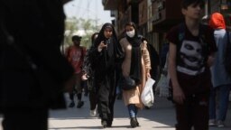 Iranian women walk on a street amid the implementation of the new hijab surveillance in Tehran, Iran, April 15, 2023. (Majid Asgaripour/West Asia News Agency via Reuters)