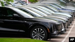 Unsold 2024 electric Lyriq sports utility vehicles sit outside a Cadillac dealership in Lone Tree, Colorado, June 2, 2024.