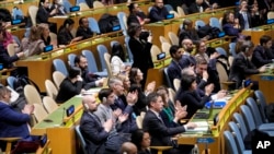 Delegations applaud after the U.N. General Assembly voted in favor of a resolution upholding Ukraine's territorial integrity and calling for a cessation of hostilities after Russia's invasion, Feb. 23, 2023, at United Nations headquarters.