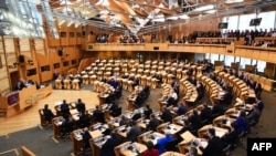FILE - A packed Scottish Parliament for the weekly First Minister's Questions in Edinburgh, Feb. 23, 2023.