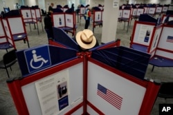 FILE - Rod Sommer fills out his ballot during early voting in Cincinnati on Oct. 11, 2023. Voters approved an amendment to the Ohio Constitution protecting abortion access on Nov. 7, 2023.