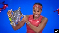 Coco Gauff, of the United States, poses for photographs after defeating Aryna Sabalenka, of Belarus, at the women's singles final of the US Open tennis championships, Sept. 9, 2023, in New York.