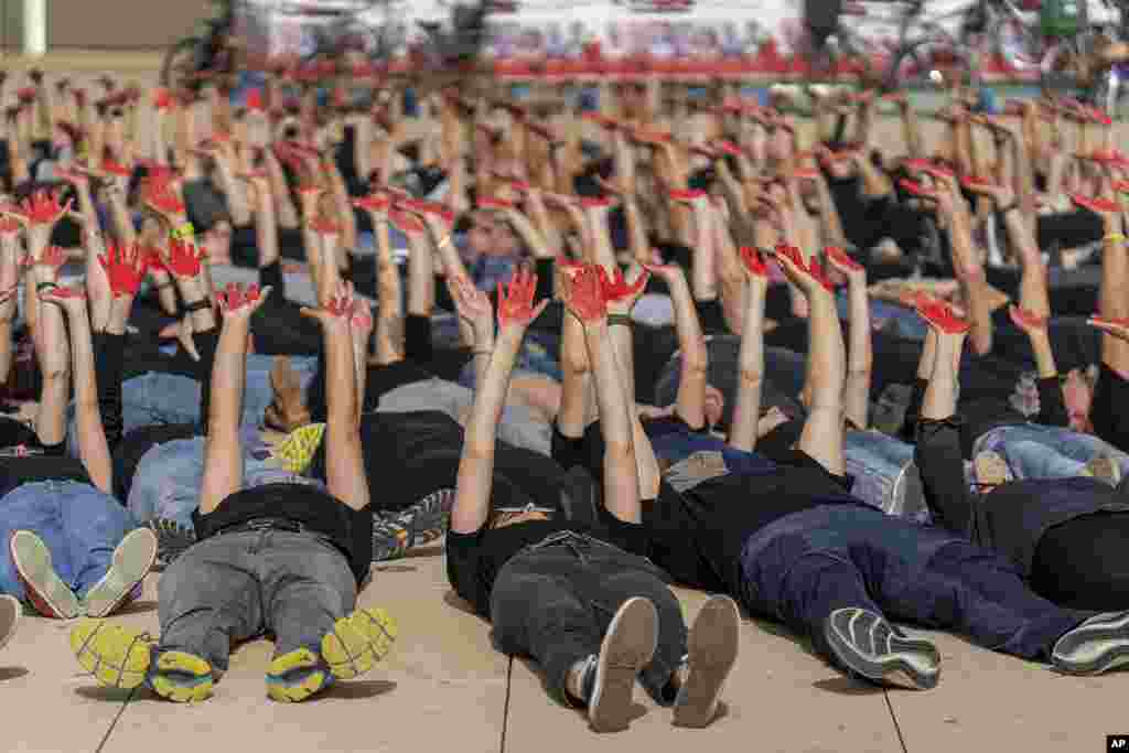 Family and supporters of hostages held in the Gaza Strip hold up their hands, painted red to symbolize blood, to call for the captives' release and to mark 200 days since the Hamas-led October 7 cross-border attack, in Tel Aviv, Israel.