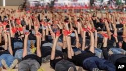 Family and supporters of hostages held in the Gaza Strip hold up their hands, painted red to symbolize blood, to call for the captives' release and to mark 200 days since the Hamas-led October 7 cross-border attack, in Tel Aviv, Israel, April 23, 2024.
