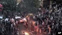 FILE - Iranians protest in Tehran on Sept. 20, 2022. A report released Sept. 22, 2023, by Iran Human Rights accuses Iranian authorities of targeting protesters' eyes when firing at them.