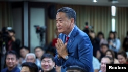 Pheu Thai's prime ministerial candidate, Srettha Thavisin, who is set to be nominated for premier in a parliamentary vote on Tuesday, greets during a party members' meeting at the party headquarter, in Bangkok, Thailand, Aug. 21, 2023. 