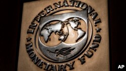 FILE - The logo of the International Monetary Fund is visible on its building in Washington, April 5, 2021. 