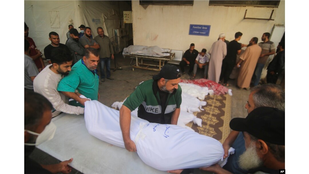 Palestinians carry the bodies of the Awaja family killed in the Israeli bombardment of the Gaza Strip in Rafahn on Friday, Oct. 20, 2023.