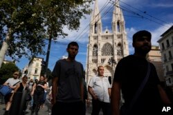 FILE - People walk past St. Vincent de Paul Church in Marseille, France, Sept. 15, 2023. France has one of Europe's most diverse populations thanks to centuries of conquest and, in the last 200 years, immigration.