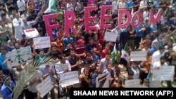 FILE - An image released by the Syrian opposition's Shaam News Network, shows an anti-regime demonstration in Habit in the restive Idlib province, May 11, 2012. Investigators in Germany and Sweden, July 3, 2024 arrested eight suspects of crimes against humanity in Syria.