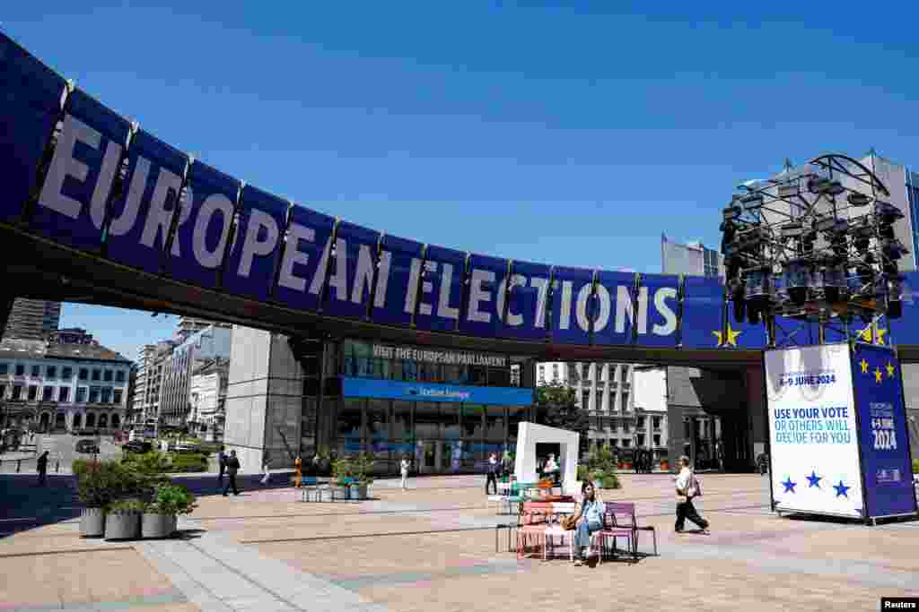 People walk near the European Parliament on the day of the European Parliament elections in Brussels, Belgium, June 9, 2024.