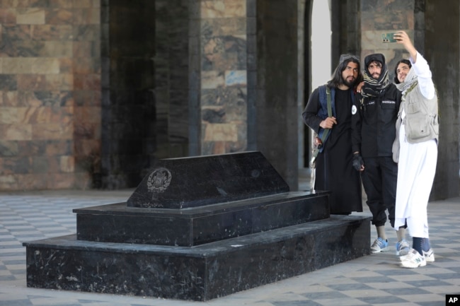 Taliban fighters take selfies by the tomb of Afghan Kind Nadir Shah in Kabul, Afghanistan, Wednesday, April 24, 2024. (AP Photo/Siddiqullah Alizai)