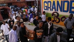 Friends and family accompany the coffin of Jhon-Roselet Joseph, killed by a stray bullet during clashes between police and gang members, in Port-au-Prince, Haiti, May 18, 2024 