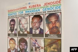 Fulgence Kayishema, top right, is seen on a wanted poster on the wall at the Genocide Fugitive Tracking Unit office, in Gishushu, in Kigali, Rwanda, on May 25, 2023.