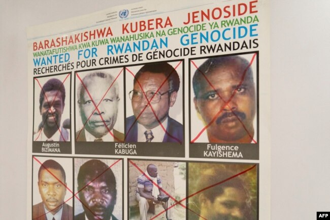 Fulgence Kayishema, top right, is seen on a wanted poster on the wall at the Genocide Fugitive Tracking Unit office, in Gishushu, in Kigali, Rwanda, on May 25, 2023.