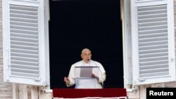 Pope Francis leads the Angelus prayer from his window, in St. Peter's Square at the Vatican, Dec. 24, 2023. 