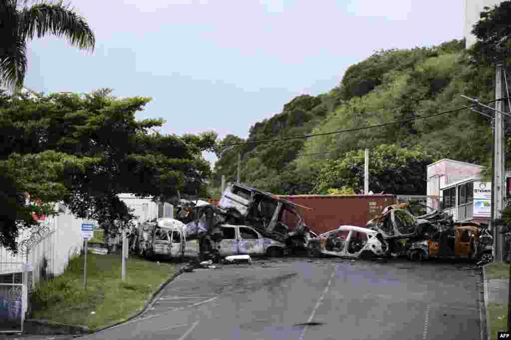 Car wreckages at a makeshift roadblock are seen at the entrance of Ducos industrial zone, in Noumea, France&#39;s Pacific territory of New Caledonia.&nbsp;Riots sparked by a constitutional reform project broke out on May 13. France has lifted a state of emergency across the territory after two weeks of unrest in which seven people died and hundreds were injured.