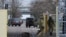 FILE - Russian service members guard the entrance to the Zaporizhzhia nuclear power plant in the Zaporizhzhia region, Russian-controlled Ukraine, March 29, 2023. The plant faces "a relatively dangerous situation" after a dam burst in Ukraine, a U.N. official said on Tuesday.