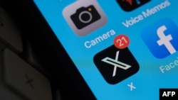 FILE - The X logo is seen on a smartphone screen July 31, 2023. New research shows that X, formerly Twitter, has seen an uptick in pro-Russian narratives among Spanish-language users in Latin America.