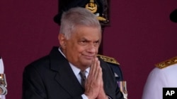 FILE - Sri Lankan President Ranil Wickremesinghe greets a group of school children during the 76th Independence Day commemoration ceremony of Sri Lanka in Colombo, Sri Lanka, on Feb. 4, 2024. 