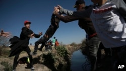 Migrants cross the Rio Grande river into the United States from Ciudad Juarez, Mexico, March 29, 2023. The image was part of a series by Associated Press photographers that won the 2024 Pulitzer Prize for feature photography.