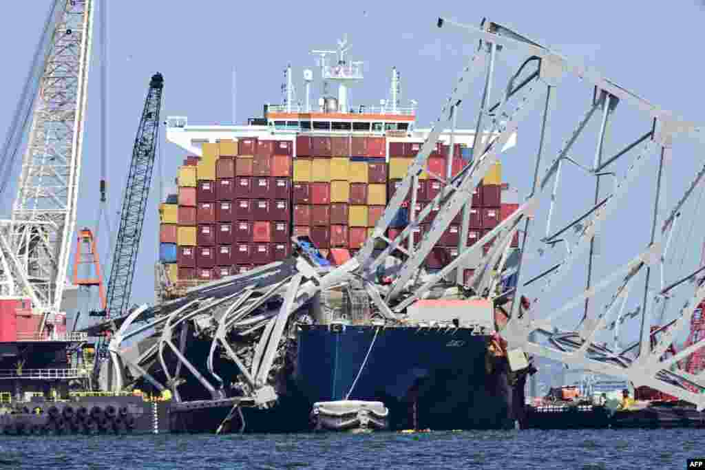 Workers continue to clear the wreckage of the Francis Scott Key Bridge and the container ship Dali in Baltimore, Maryland.&nbsp;The first cargo ship passed through a temporary channel in Baltimore on April 25, after being trapped in the harbor since the bridge collapsed on March 26, 2024.