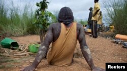 FILE - An artisanal gold miner takes a rest at a small-scale gold mine in Kalana August 26, 2012. 